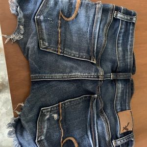 ripped dark wash shorts